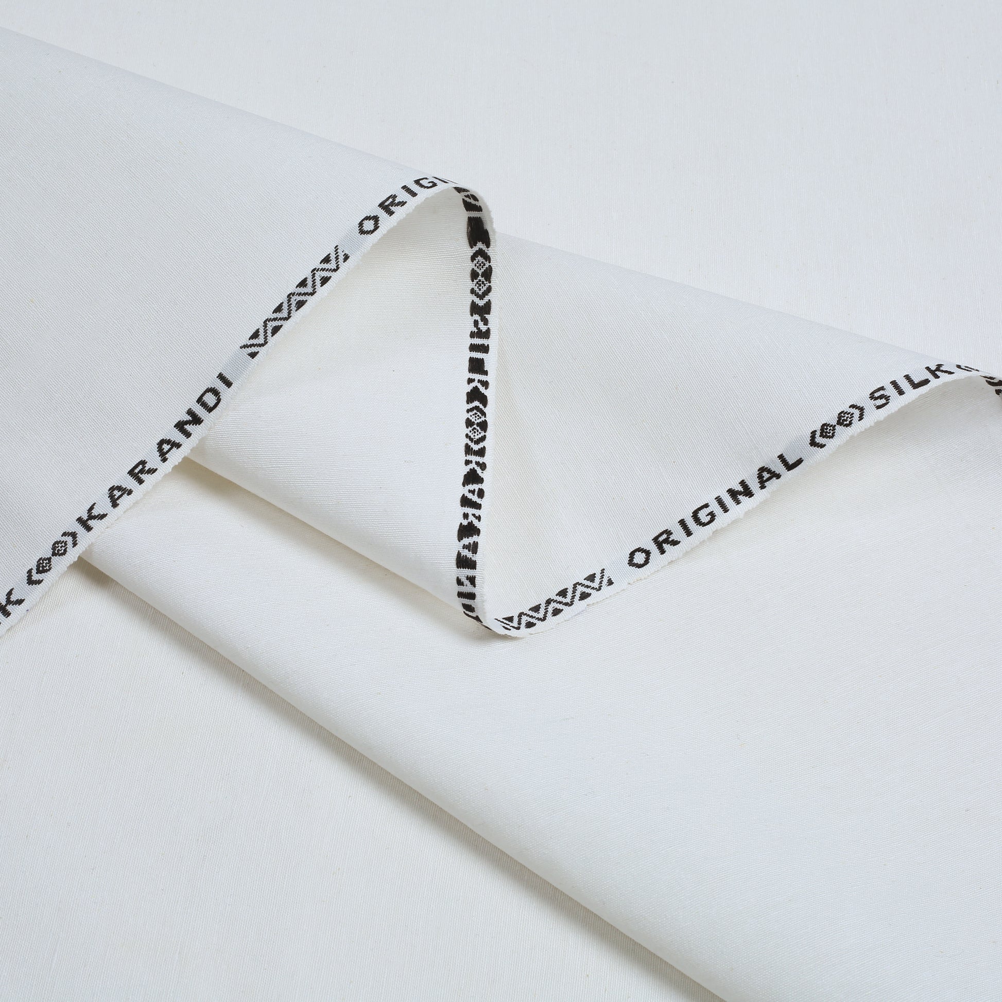 White fabric with black text on a white background