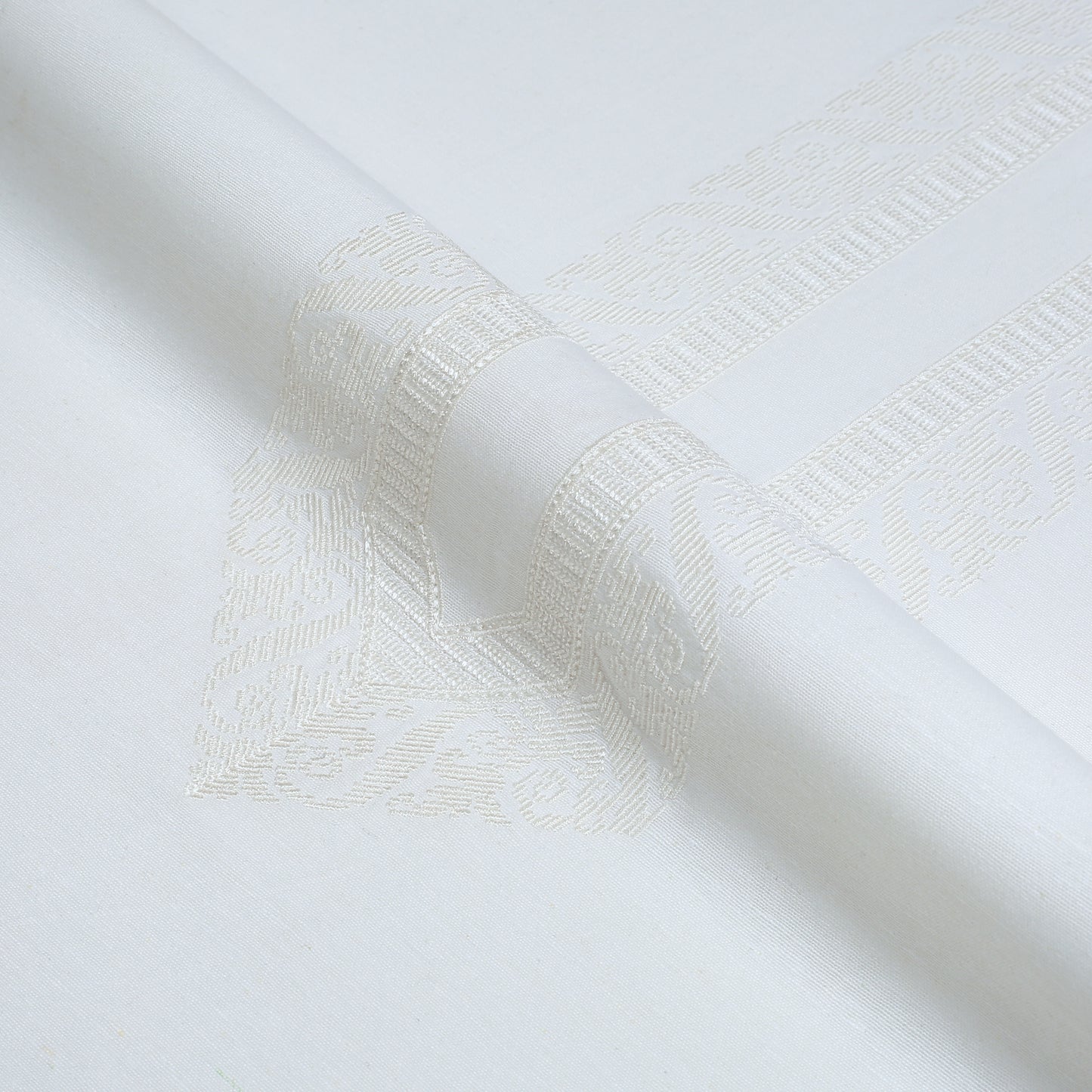 Close-up of textured white fabric with a subtle pattern
