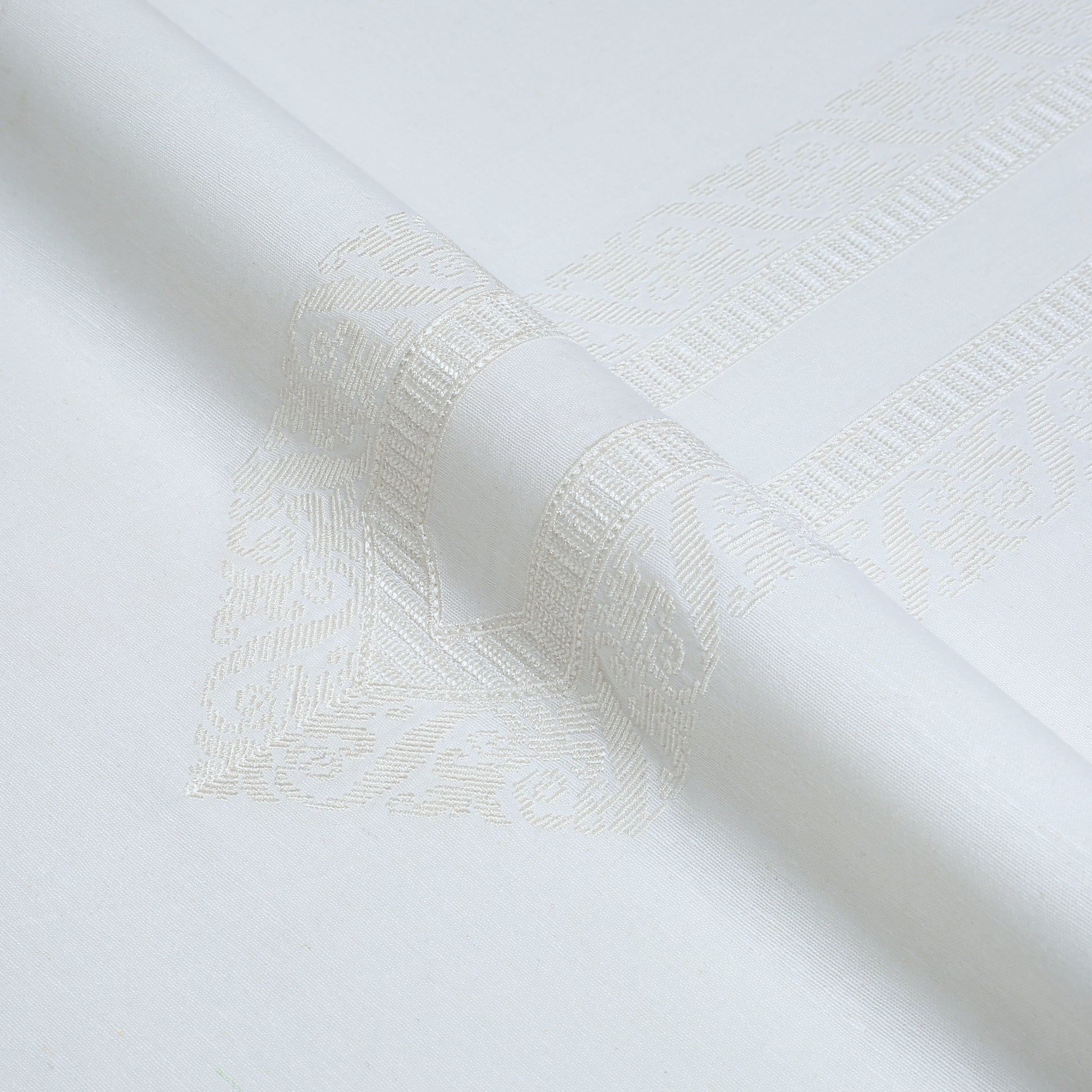 Close-up of textured white fabric with a subtle pattern